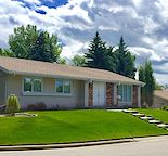 Updated bungalow with open kitchen, large deck and insulated double garage