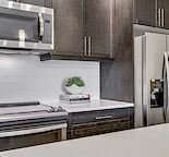 New condition top floor 1 bedroom and den with underground parking and storage.