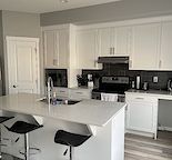 Home with basement kitchenette, fenced yard, and heated oversized double garage