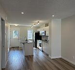 Townhome style condo with a large loft and balcony and fenced backyard