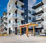 ALL INCLUSIVE CORNER CONDO WITH HEATED PARKING STALLS (2) AND LAMINATED FLOORING