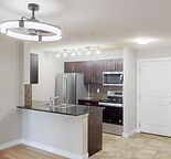 Fully Renovated Ground-Floor 2 Bed + Den in Legacy – Heat, Water & Underground Parking Included